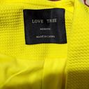 Love Tree neon electric yellow fitted blazer jacket -M  Gently used and in very good condition, size medium (but runs a bit small due to fitted style). Bright vibrant neon electric yellow with texture to the fabric. Please note modeled photos vary slightly in style but all flat photos and modeled pic on the mirror are of exact blazer for sale. Photo 3