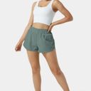 Halara  High Waisted Dolphin Hem Shorts Green Size L NWT Photo 3