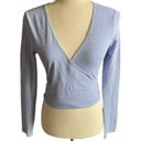 Brandy Melville Beautiful blue with tiny white flowers wrap top, long sleeves, has stretch, excellent condition, size medium Measurements: Bust: armpit to armpit 16 inches  Length: shoulder seam to bottom 17 inches Photo 0