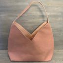 Hobo pink and tan shoulder bag with a unique asymmetrical design, featuring a side zipper closure Photo 3