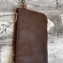 Brown cowhide with gold acid wash. 10”x6” wristlet with removable strap. Photo 4