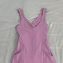 Free People Movement Here On Out Strappy Onesie Romper   Size XS  Condition: NWT  Color: bright orchid   Details : - See photo for approx. inseam measurement laying flat  - Built-in bra - not padded - Side pockets. Photo 1