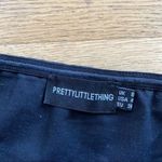 Pretty Little Thing Bandeau Zip Front Crop Top in Black Photo 1