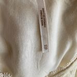 Free People -DONT YOU DARE Stunning cream color lace dress, sleeveless, lined, front keyhole opening, V back, skirt has some gold shimmer, excellent condition, size XS Measurements: Bust: armpit to armpit 15 inches Length: shoulder seam to bottom 33 inches Photo 11