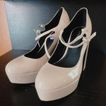 Guess Women's Callyna Platform Round Toe Mary Janes Pump Nude Beige Size 8.5 NEW New with tag Same day shipping Smoke and pets free Slay your elegant look wearing the Callyna platform pump making accent to any ensemble. Patent synthetic upper Adjustable double buckle straps closure Round toe Synthetic lining 4” heels, 1.5" platform, 5.5" covered block heel Synthetic sole Elevate your shoe game with these Women's Callyna Platform Round Toe Mary Janes Pumps in Nude Beige. These patent leather pumps boast an ultra-high block heel and a platform sole, providing both style and comfort. The round toe and adjustable buckle strap make for a perfect fit, while the ivory color and solid pattern make them versatile for any occasion. These women's size 8.5 heels feature the iconic character Marie and are a new addition to your wardrobe, ready to take on the town. Photo 6