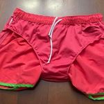 Adidas Women's Vibrant Red Athletic Shorts with Green Trim are a size Large. Photo 7
