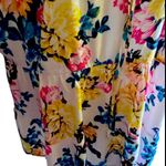 Torrid NWT- Stunning white with bright colorful flowers, babydoll style, ties in front, flutter sleeves, lightweight, the perfect summer top, brand new, size 2x Measurements: Bust: armpit to armpit 25 inches Waist: side to side 22-27 inches Length: shoulder seam to bottom 30 inches Photo 2