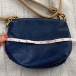Charming Charlie small blue crossbody bag with tan strap. Photo 8