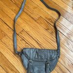 Gray studded faux leather cross body bag. Magnetic snaps on the front. Photo 2