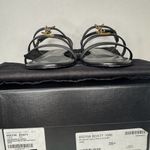 Saint Laurent CASSANDRA LEATHER WITH GOLD EMBLEM HARDWARE IN BLACK SANDALS. Photo 5