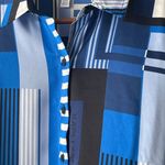 Karl Lagerfeld NWT  Paris Geometric Logo Blouse button up Long Sleeve shirt Blue choose your size msrp $89 All size available  New with tag  Same day shipping  Smoke and pets free  Add a luxurious touch to your wardrobe with this  Paris Geometric Logo Blouse button up Long Sleeve shirt. The shirt features a stylish geometric pattern in blue, black, and white colors, perfect for any occasion. It comes in sizes S/M/L/XL and is made of lightweight, breathable polyester that makes it suitable for all seasons. Super silky flowy.   The shirt's oversized design and packable feature make it a perfect addition to your fashions. The shirt is a part of the Paris Theme and has long sleeves, ideal for the colder months. The shirt is suitable for any size and does not compromise on quality. Photo 6