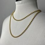 Gold beaded necklace with golden eyelet Photo 0