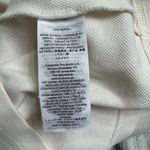 Tory Burch Emily Ruffled Pique Polo Shirt in Ecru. Photo 4