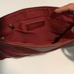 Carlos Santana  burgundy clutch Photo 3
