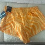 DICK'S Sporting Goods DSG women’s yellow mid rise stride running shorts  Photo 2