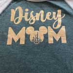 Disney NWT- STORE adorable “ Mom” tshirt, light pink 3/4 sleeves, gray shirt with gold lettering. Brand new. Size xs Photo 1