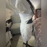 Short white dress with a modern and elegant design. It features long sleeves, Size M Photo 5