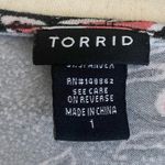 Torrid -WOMENS BABYDOLL TOP-SIZE 1X Black with pink and white flowers, has stretch, buttons down the front, short sleeves, 95% rayon 5% spandex, excellent condition Measurements: Bust: armpit to armpit 24 inches Length: shoulder seam to bottom Front: 29 inches Back: 32 inches Photo 6
