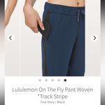 Lululemon  On The Fly Woven Track Black Stripe Pant in True Navy, Size 10 Photo 4