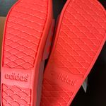 Adidas ADILETTE COMFORT K sandals pink orange super soft comfy light weight NWT New with tag Same day shipping Smoke and pets free Get ready to step up your style with these Adilette Comfort K sandals! These sandals are perfect for those who want to look fashionable while staying comfortable. With a super soft and lightweight design, these sandals are perfect for all-day wear. The pink and orange striped pattern adds a pop of color to your outfit, making them a great choice for any occasion. These sandals come in a UK shoe size 5, US shoe size 5, and EU shoe size 37. The synthetic upper material and comfort slide product line ensure that your feet will stay cool and comfortable no matter where you go. Don't miss out on the chance to add these stylish and comfortable sandals to your shoe collection! Photo 8