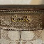Coach  signature Charlie C zip around wallet gold with purple interior Photo 2