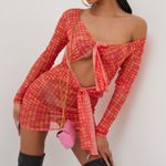 EGO LONG SLEEVE KNOTTED CUT OUT DETAIL MINI BODYCON DRESS IN PINK SPOTTY MESH Photo 1
