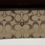 Coach TAN AND BROWN WALLET
PLEAT DESIGN…SIGNATURE LOGO DESIGN
SNAP CLOSURE Photo 2