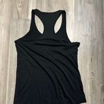 Orangetheory Size S black Racerback tank with skull and cross bones.  Pit to pit is 17, length is 25 Photo 1