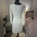 Short white dress with a modern and elegant design. It features long sleeves, Size M Photo 2