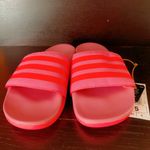 Adidas ADILETTE COMFORT K sandals pink orange super soft comfy light weight NWT New with tag Same day shipping Smoke and pets free Get ready to step up your style with these Adilette Comfort K sandals! These sandals are perfect for those who want to look fashionable while staying comfortable. With a super soft and lightweight design, these sandals are perfect for all-day wear. The pink and orange striped pattern adds a pop of color to your outfit, making them a great choice for any occasion. These sandals come in a UK shoe size 5, US shoe size 5, and EU shoe size 37. The synthetic upper material and comfort slide product line ensure that your feet will stay cool and comfortable no matter where you go. Don't miss out on the chance to add these stylish and comfortable sandals to your shoe collection! Photo 1