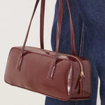 ASOS - burgundy patent faux leather elongated shoulder bag Photo 0