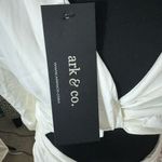 Short white dress with a modern and elegant design. It features long sleeves, Size M Photo 4