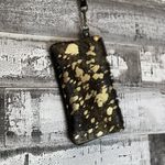Metallic leather acid wash black and gold wristlet With removable strap. Photo 1