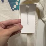 Urban Outfitters  Cream Top with Blue Butterfly Photo 1