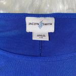 Jaclyn Smith  Blue and Black Top With a Tie Up Bow On The Side Photo 1