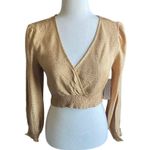 Kirious NWT- LOS ANGELES-SIZE SMALL Gorgeous gold color crop top, elastic bottom, v neck, open back, long sleeves, size small Measurements: Bust: armpit to armpit 15 inches  Length: shoulder seam to bottom 15 inches Photo 0