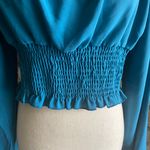 SheIn NWOT--BLUE/GREEN LONG SLEEVE CROP TOP-SIZE LARGE Beautiful crop top, color is a blue green color, puff long sleeves, smocked bottom, 80% polyester and 29% cotton, excellent condition, size large Measurements: Bust: armpit to armpit 19-20 inches Length: shoulder seam to bottom 17 inches Photo 5
