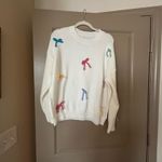 White sweater with colorful bow detailing Size M Photo 1