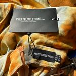 Pretty Little Thing β
NWT Ruched Side Midi skirt - Orange Tie Dye β
Photo 13