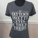 Port & Company Tattoos, Pretty Eyes, and Thick Thighs Short Sleeve Graphic Tee Size Medium Photo 0