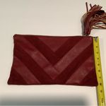 Carlos Santana  burgundy clutch Photo 7