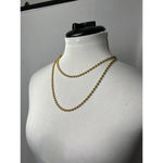 Gold beaded necklace with golden eyelet Photo 1