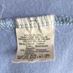 Brandy Melville Beautiful blue with tiny white flowers wrap top, long sleeves, has stretch, excellent condition, size medium Measurements: Bust: armpit to armpit 16 inches Length: shoulder seam to bottom 17 inches Photo 5