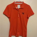 Gilly Hicks  Vibrant Orange Polo Shirt Photo 0