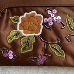 Avon NWOT Y2k chocolate brown clutch with floral design. Photo 5