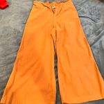 The Comfy Boutique burnt orange flared pants  Size small  Stretchy/ super  Color is like a burnt orange/brown  Photo 0