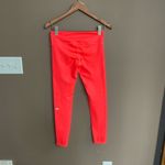 Alo Yoga Alo Mid Rise Stash Pocket Leggings in Bright Coral Size Small Photo 1