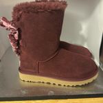 UGG  snow boots size women’s five. Absolutely adorable burgundy color with bows.​ Photo 1