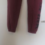 PINK - Victoria's Secret  sweatpants with pink pink on left bottom leg in burgundy red and black in small. Photo 3