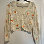 Blue Steel Medium Cream Open Knit Button cardigan w/ Orange Embroidered Hearts. Photo 0